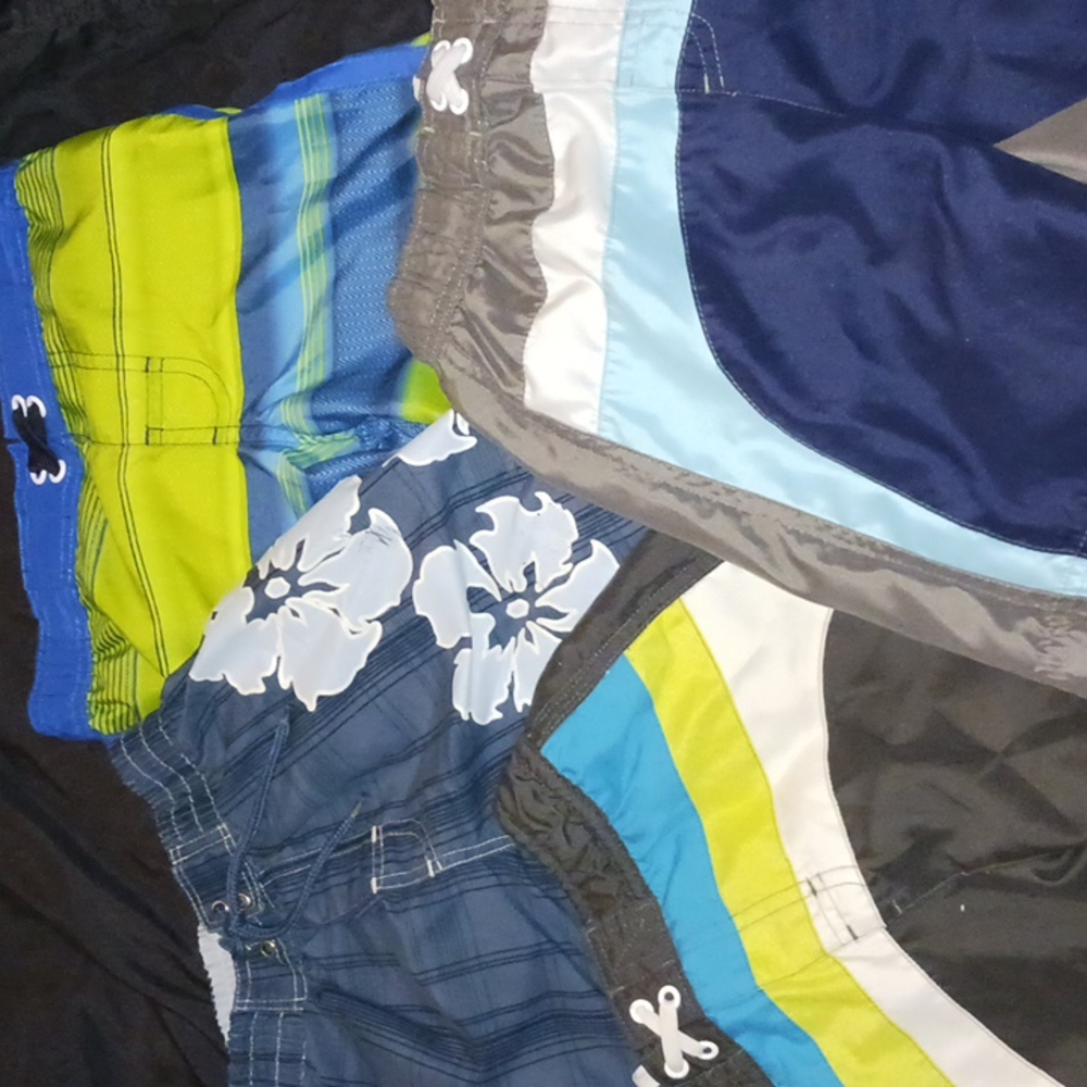 4 pairs of swim trunks, boys size 4T and XS (4-5).